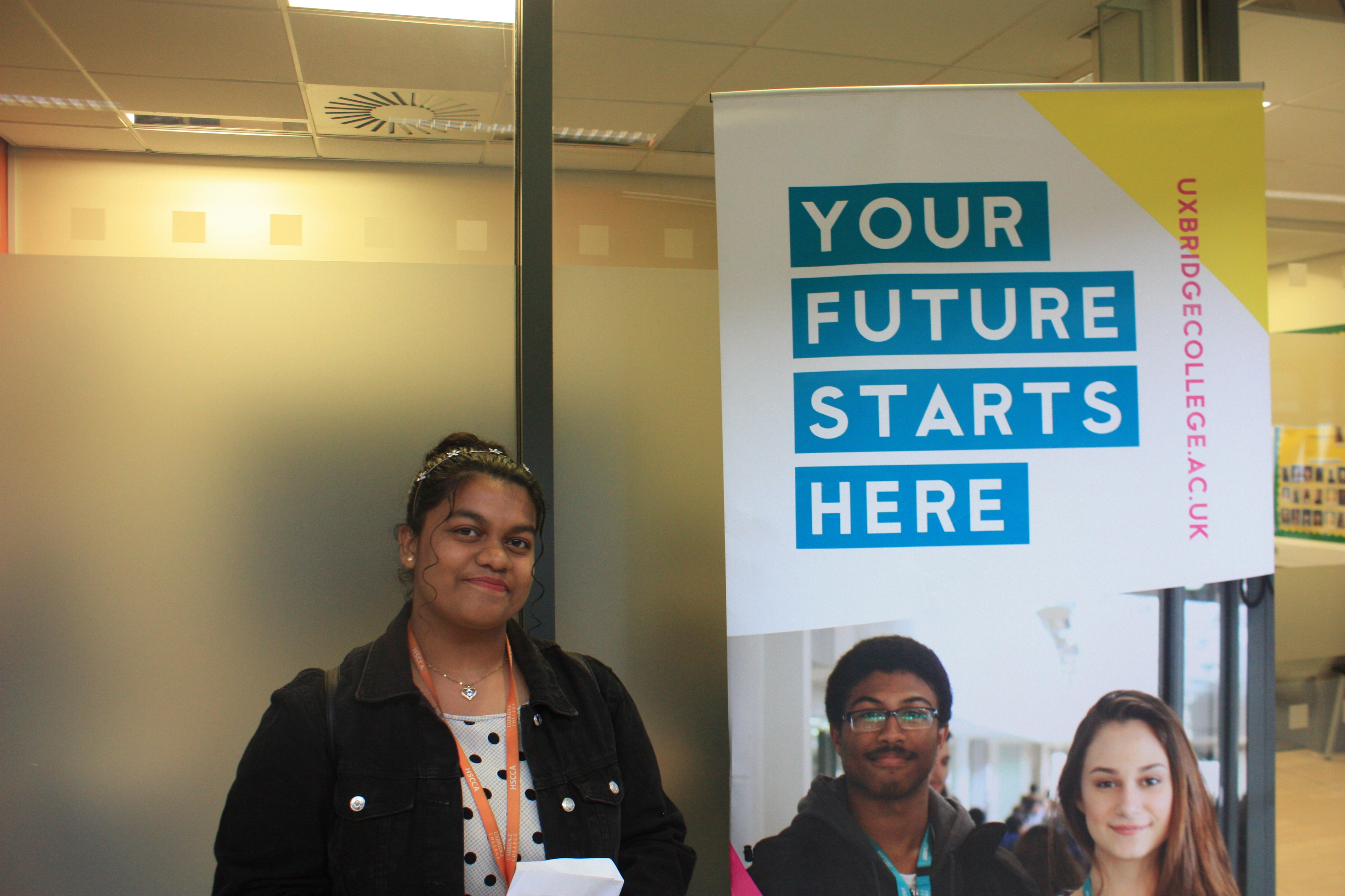Picture of a female student looking happy having just opened up their results