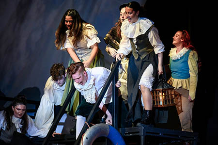 Praxis Performing Arts Student in costume, performing on stage. 