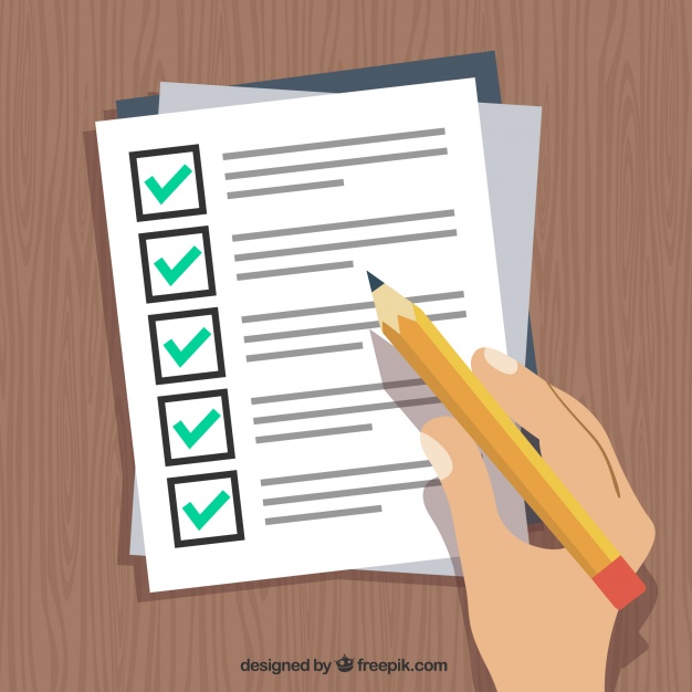 Hand holding pen and filling out form 