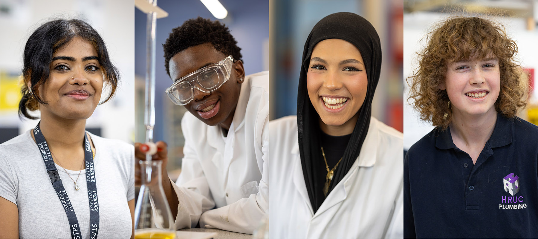 Four Uxbridge College students smiling. A girl with long hair pulled back and a nose piercing, a boy wearing a lab coat and protective glasses, a girl in a lab coat, a boy with long curly hair.