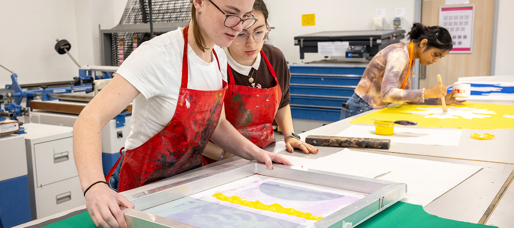 2 Art and Design students at Uxbridge College working on a screenprinting project