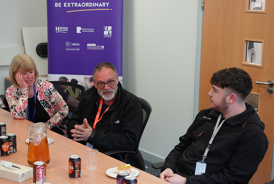 Picture of apprentice Ryan and his employer having a discussion with Jo Withers, principal of Harrow College.