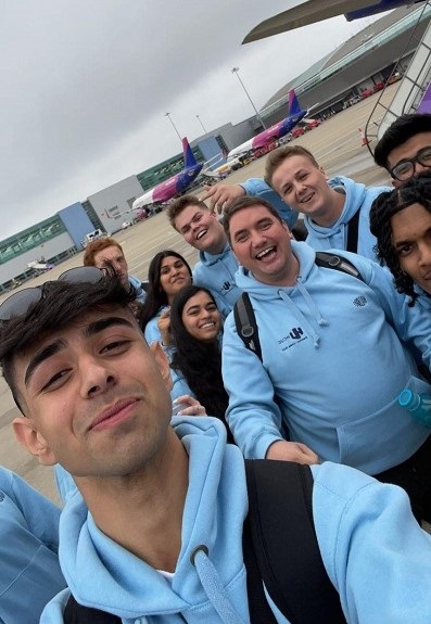 Group of smiling students at an airport