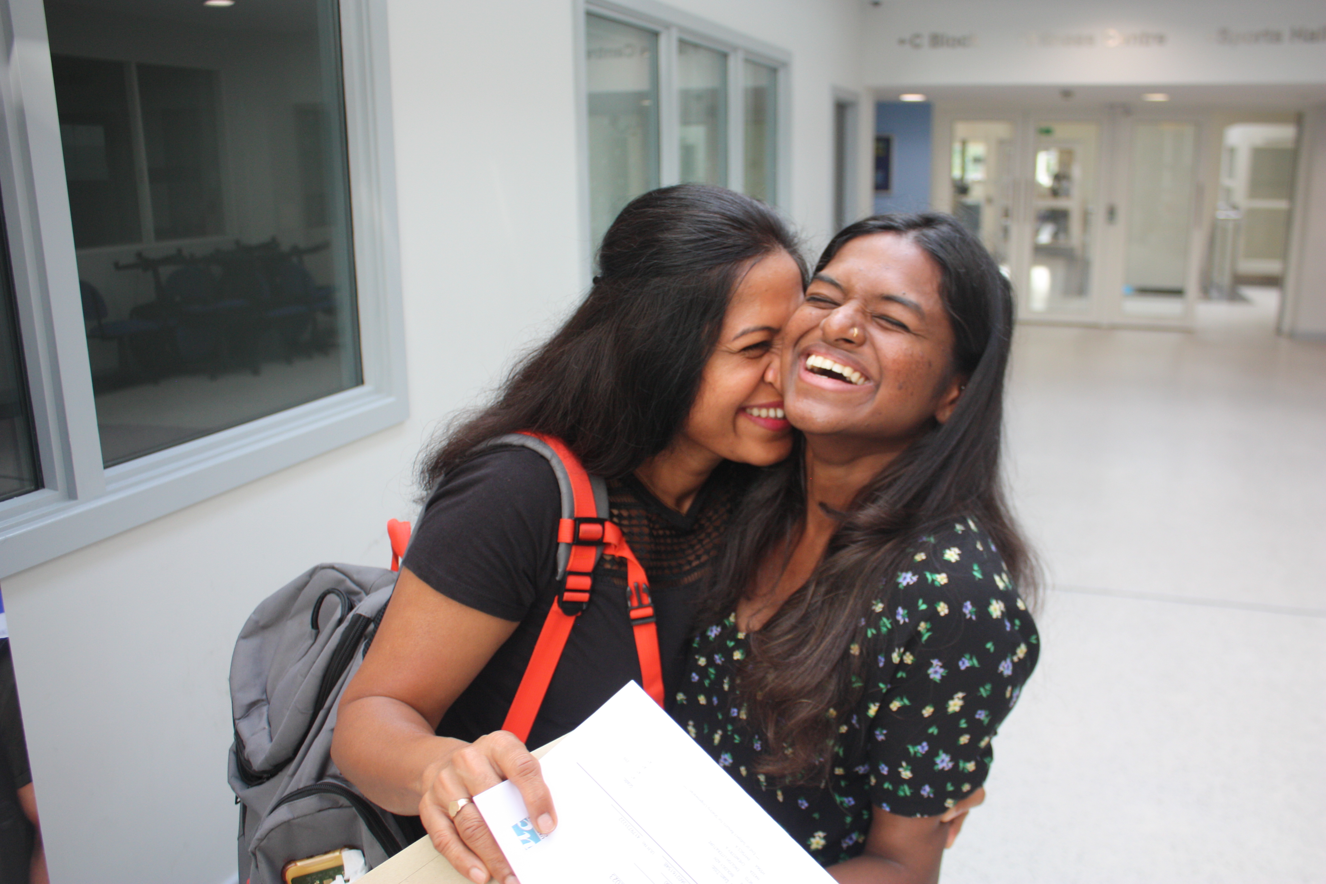 Picture of A Level student with her mum receiving her results