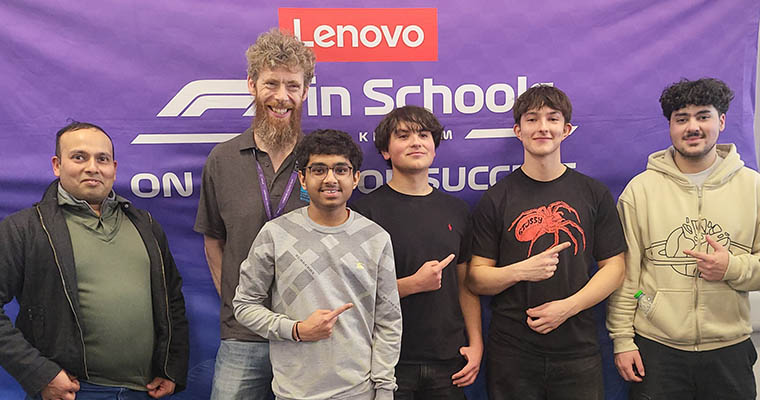 Our Uxbridge College Engineering students F1 in Schools Team and College staff posing for a photo in front of the Lenovo purple banner.