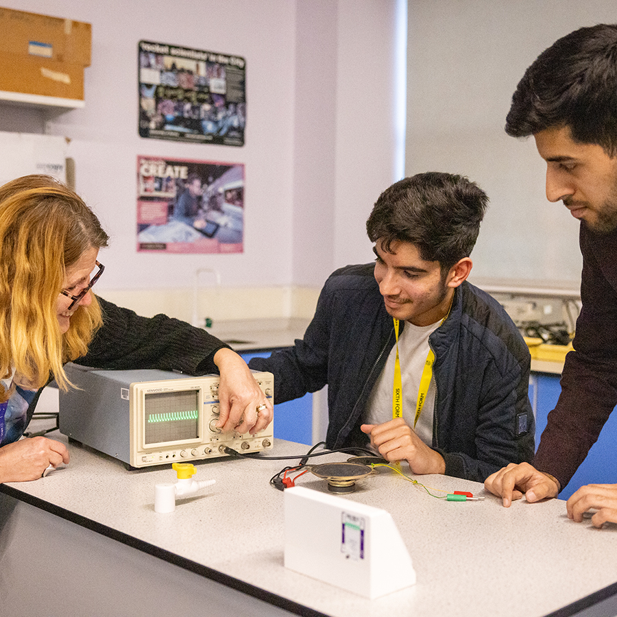 Sixth Form students from Uxbridge College getting taught about Science. Teacher is demonstrating how to use an oscilloscope.