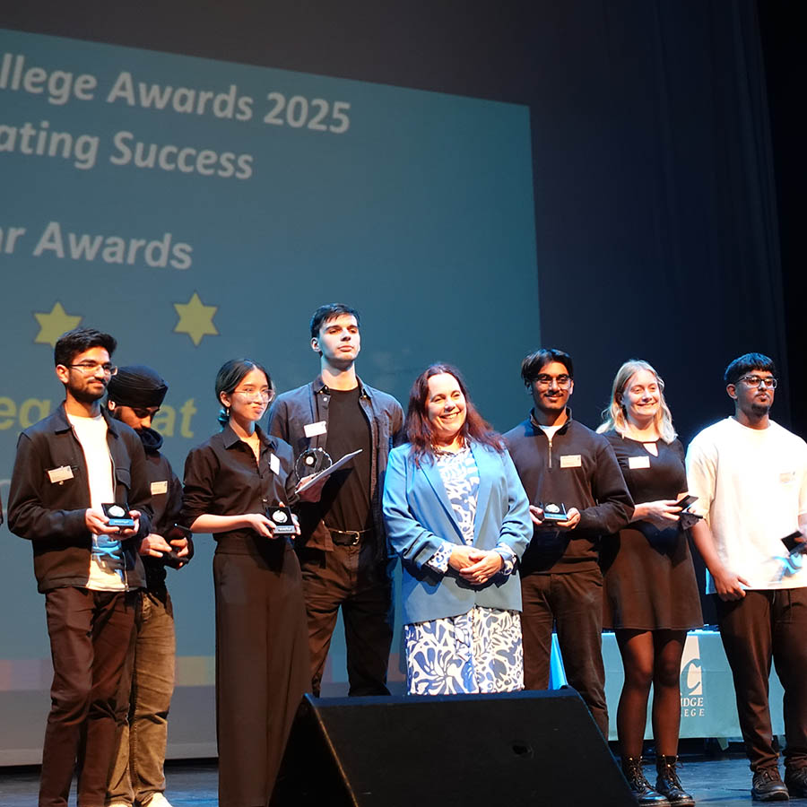 A group of Uxbridge College Students at the Uxbridge Student Awards Ceremony, on stage holding their awards. They are posing for a photo with Jo Salter MBE, Britain’s first female jet pilot.