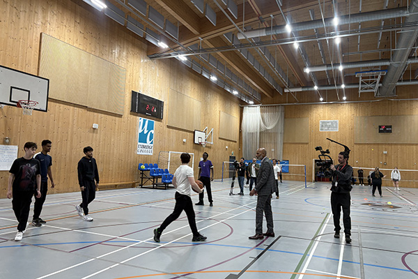 Meet the Principal Video behind the scenes footage - Clive is in the Uxbridge sports hall, playing basketball with students.