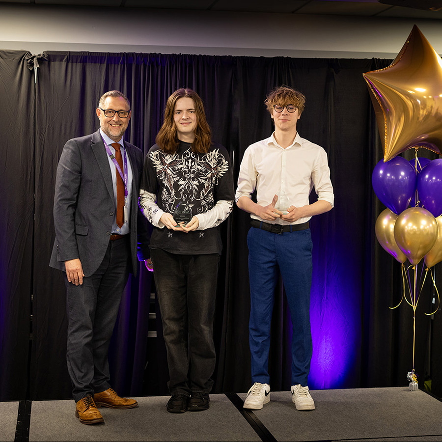 Male Uxbridge College students winning an award at the HRUC Skills Competition Awards Ceremony, presented by Kai Barnes, Assistant Principal at Richmond upon Thames College, part of HRUC.    